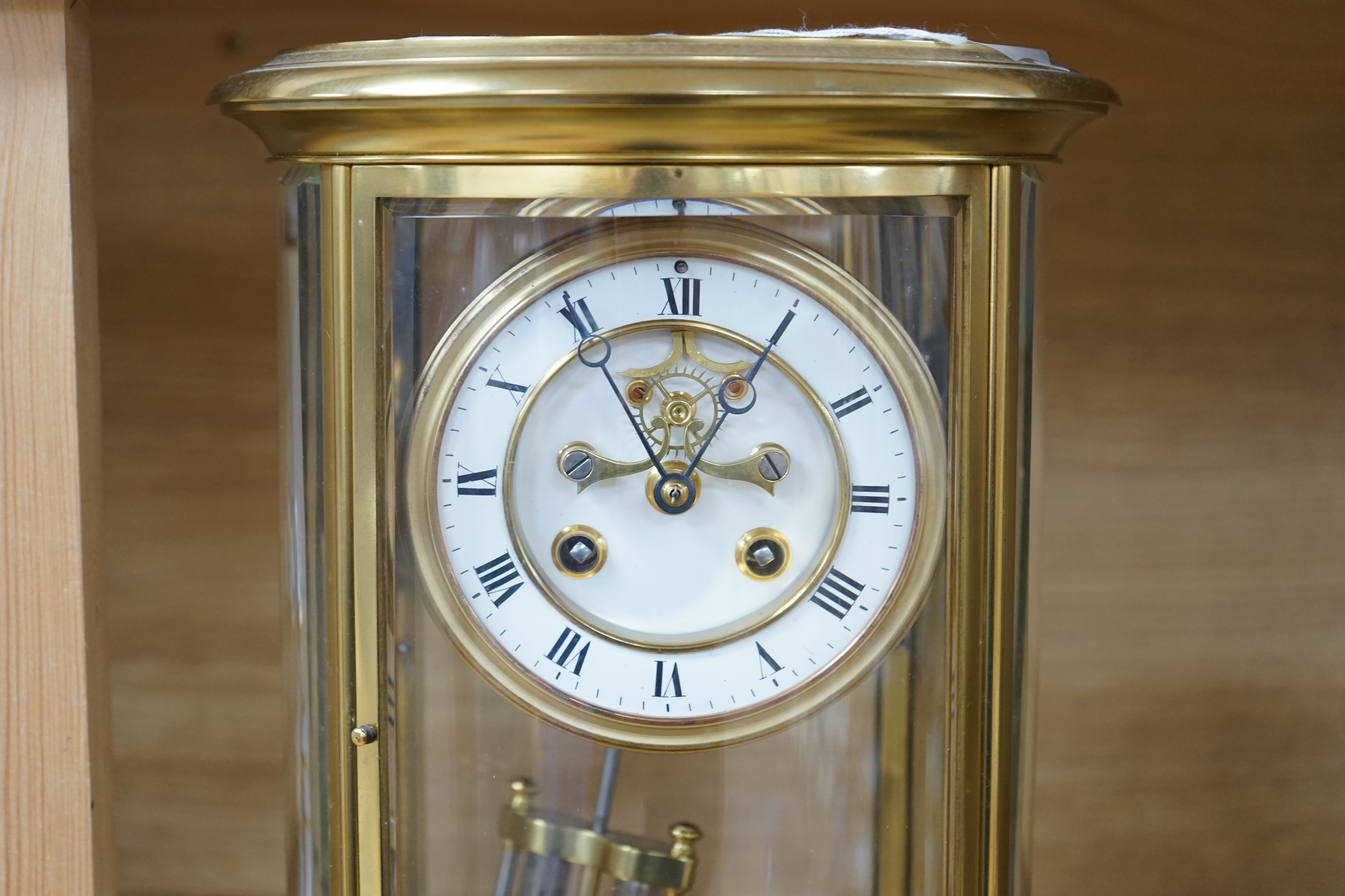 A 19th century French gilt brass oval four glass mantel clock with Brocot escapement, 30cm high. Condition - good